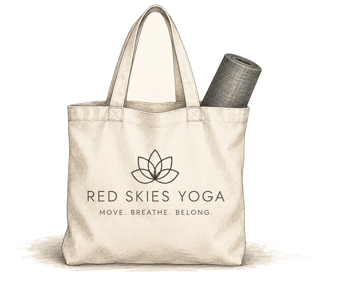 A hand-drawn Red Skies Yoga canvas tote with a rolled mat inside
